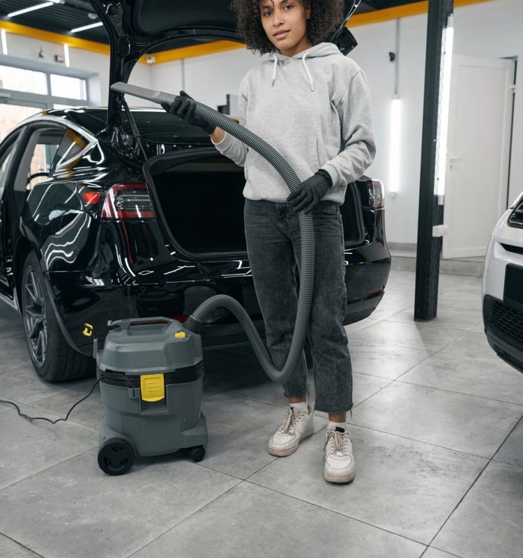 auto-detailer-standing-beside-motor-vehicle-with-open-trunk.jpg