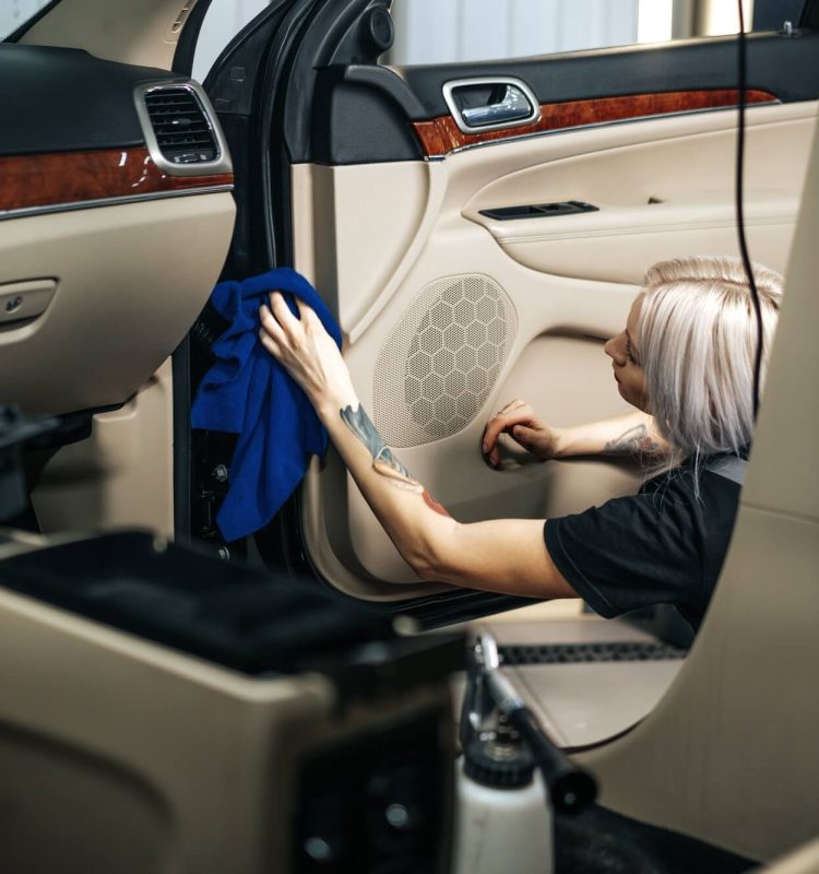 woman-cleaning-car-salon-with-polishing-spray-in-car-detailing-service-1.jpg